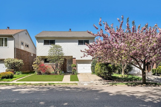 traditional home with concrete driveway, brick siding, and an attached garage