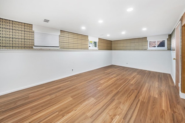 below grade area featuring baseboards, recessed lighting, wood finished floors, and visible vents