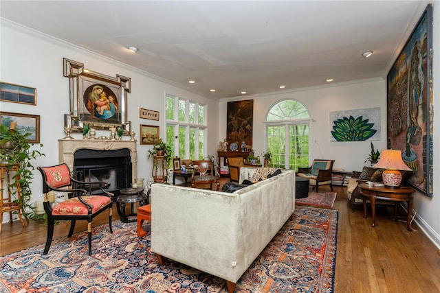 living room with a high end fireplace, ornamental molding, wood finished floors, and recessed lighting