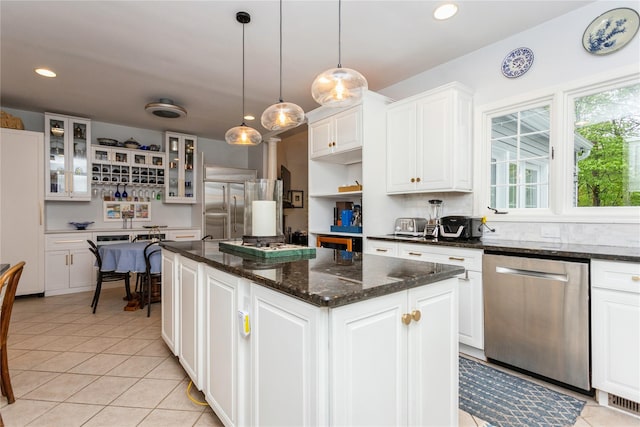kitchen featuring stainless steel appliances, a kitchen island, recessed lighting, white cabinetry, and light tile patterned floors