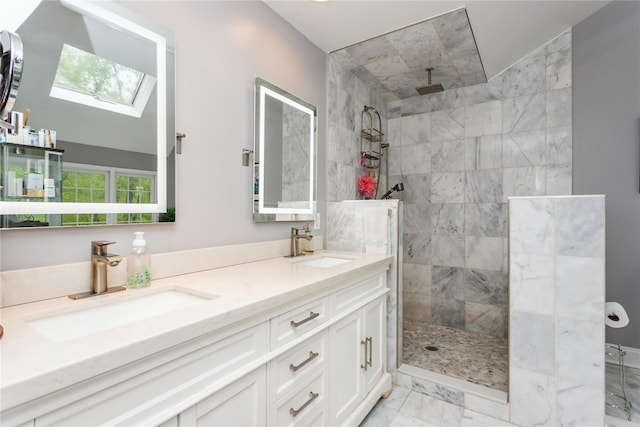 full bath with marble finish floors, double vanity, a walk in shower, and a skylight