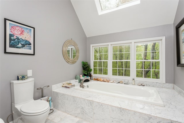 bathroom with toilet, a bath, lofted ceiling, a skylight, and marble finish floors