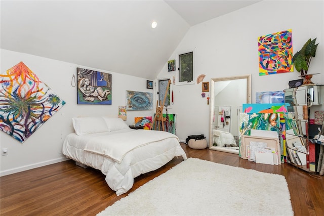 bedroom with lofted ceiling, wood finished floors, baseboards, and recessed lighting
