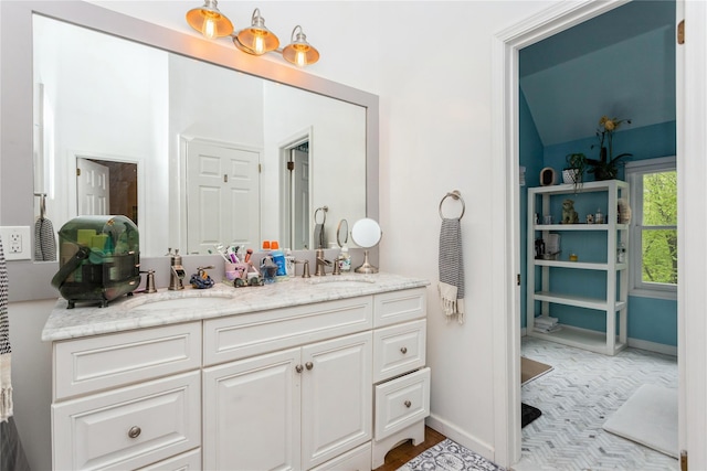 bathroom featuring double vanity and baseboards