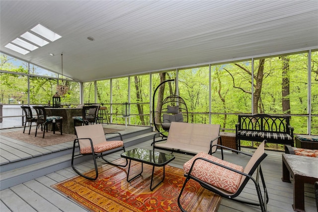 sunroom / solarium with a skylight, an outdoor living space, and vaulted ceiling