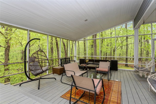 sunroom / solarium featuring an outdoor hangout area and lofted ceiling