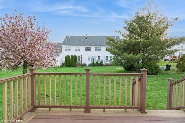 wooden deck featuring a yard
