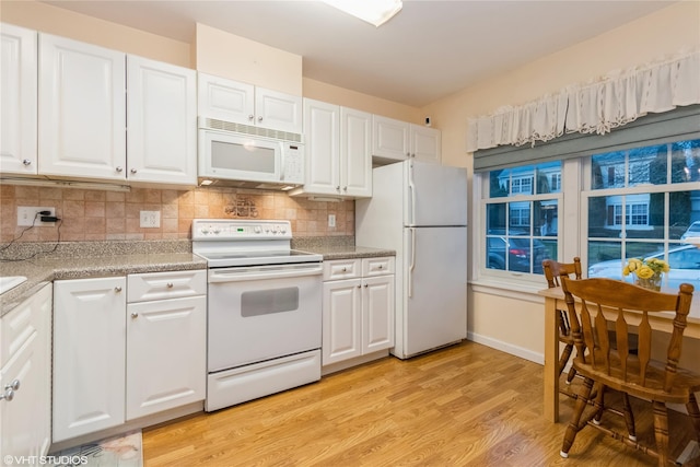 kitchen with light countertops, decorative backsplash, white cabinets, and white appliances