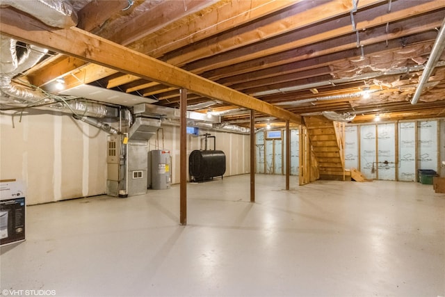 unfinished below grade area with heating unit, heating fuel, stairway, and electric water heater