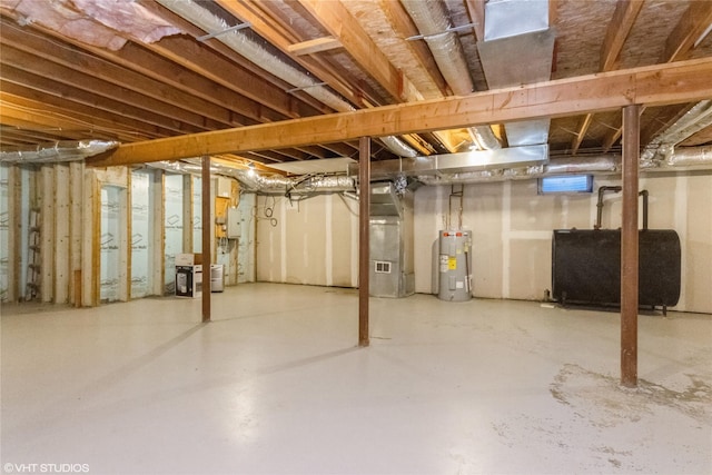 unfinished basement featuring water heater, heating unit, and heating fuel