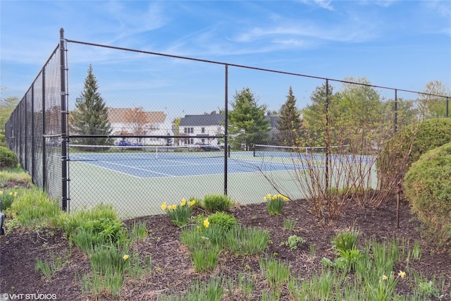 view of tennis court with fence