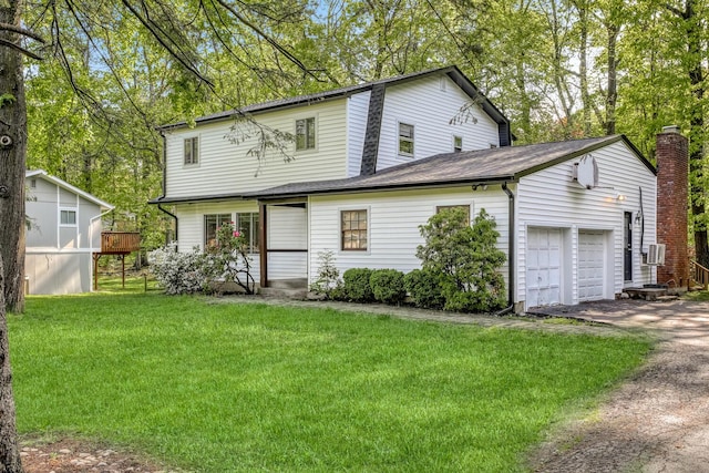 view of front of home with driveway, a front lawn, and a garage