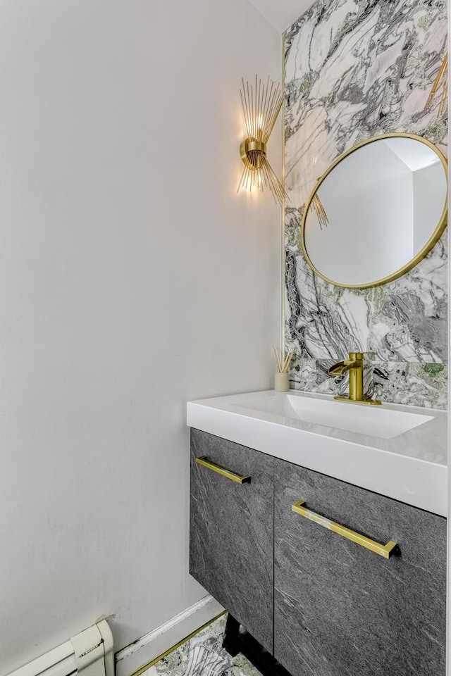 bathroom featuring vanity and marble look tiles
