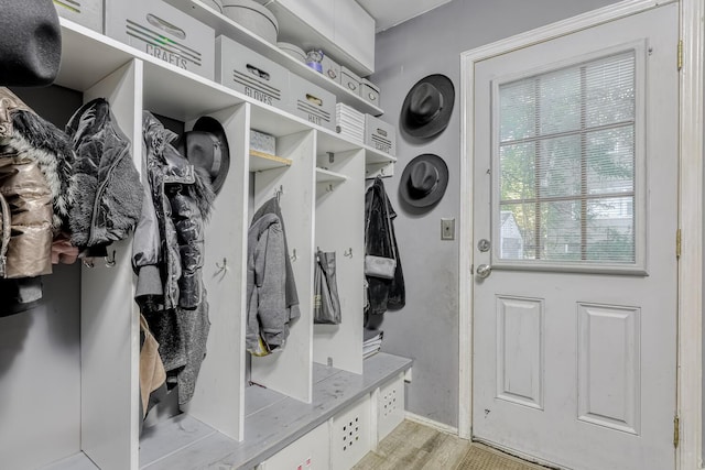 mudroom with light wood finished floors and baseboards