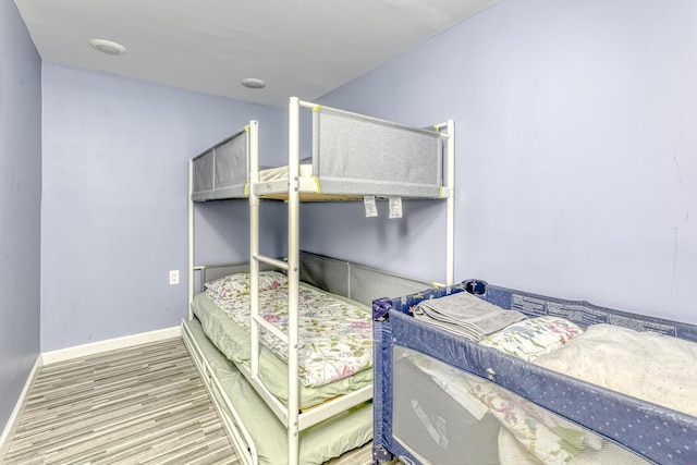 bedroom featuring wood finished floors and baseboards