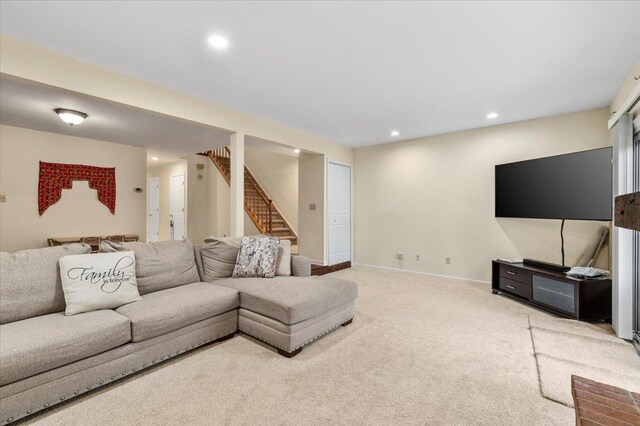 carpeted living area featuring recessed lighting, baseboards, and stairway