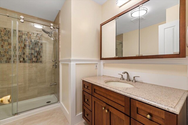 full bath featuring vanity and a stall shower