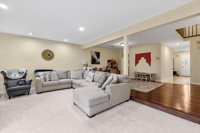 living room featuring recessed lighting, baseboards, and light wood-type flooring