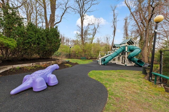 communal playground featuring a lawn