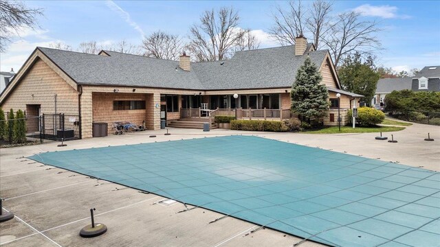 view of pool with fence, a fenced in pool, a gate, central AC unit, and a patio