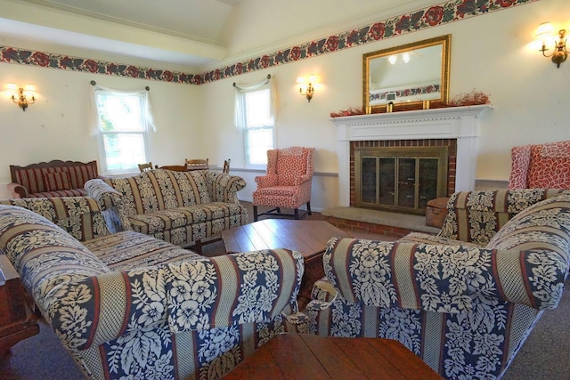 living area featuring vaulted ceiling and a brick fireplace