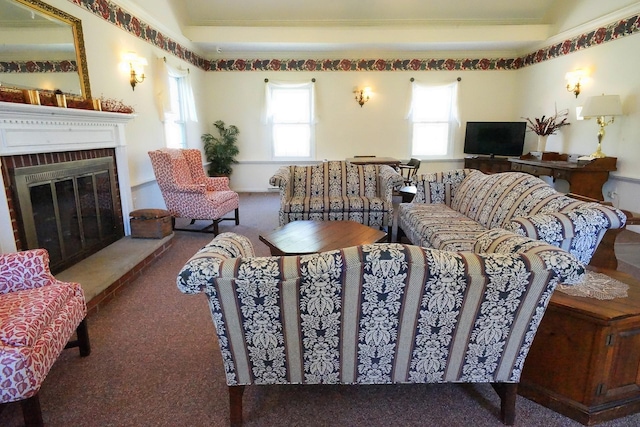 living area with a brick fireplace and carpet