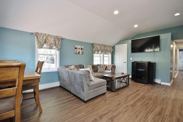 living area featuring baseboards, a baseboard radiator, lofted ceiling, and wood finished floors