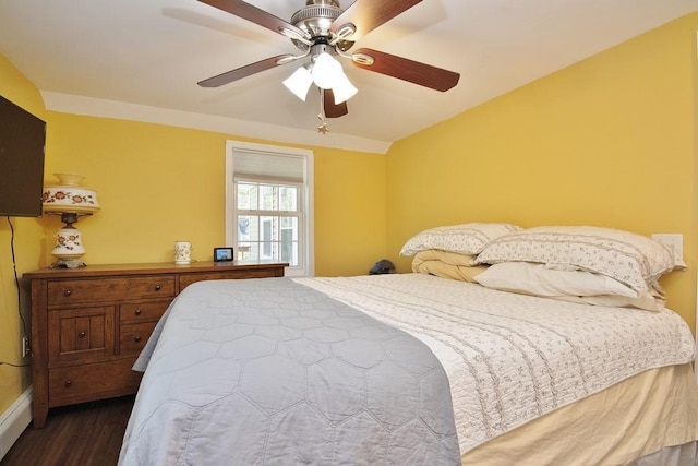 bedroom with ceiling fan, baseboards, and dark wood-type flooring