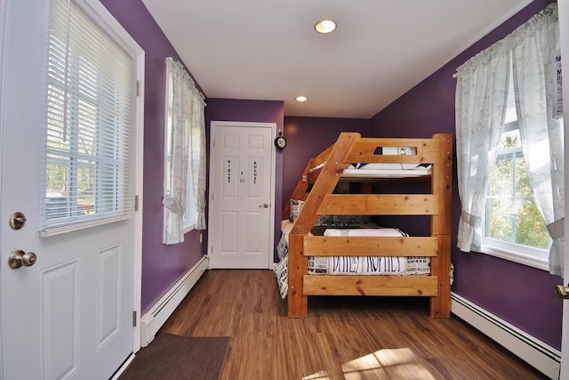bedroom with recessed lighting, baseboards, wood finished floors, and a baseboard radiator