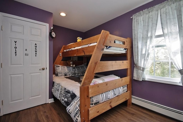 bedroom featuring recessed lighting, baseboards, wood finished floors, and a baseboard radiator