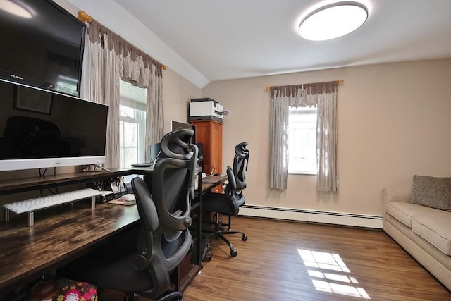 office space with plenty of natural light, baseboard heating, and wood finished floors