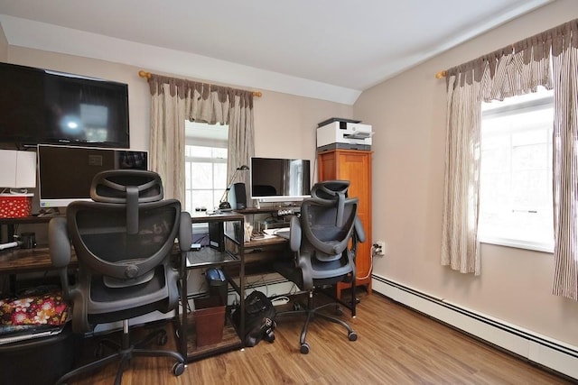 office featuring wood finished floors and a baseboard heating unit
