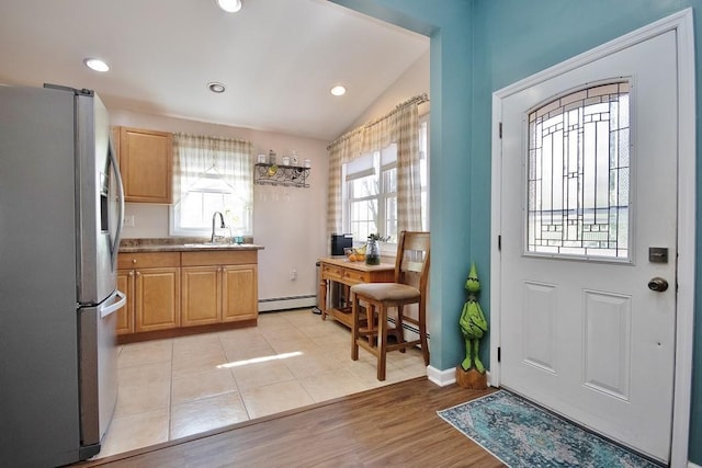entryway featuring lofted ceiling, baseboards, recessed lighting, light wood-type flooring, and a baseboard heating unit