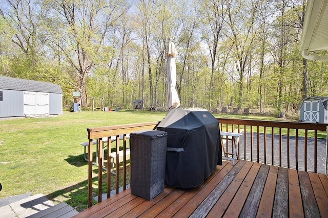 wooden deck featuring a lawn, an outdoor structure, and a shed