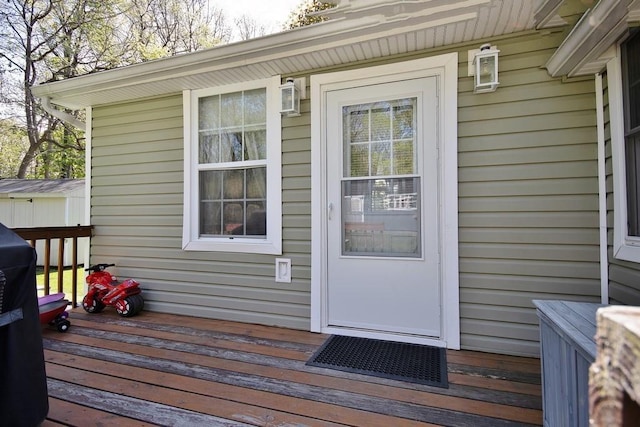doorway to property featuring a wooden deck