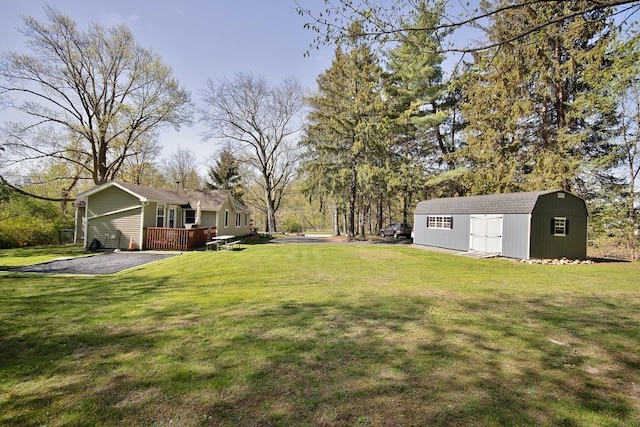 view of yard featuring a shed, an outbuilding, and a deck
