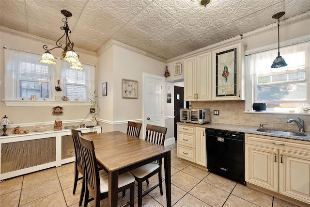 kitchen featuring cream cabinets, a sink, radiator, black dishwasher, and light tile patterned floors