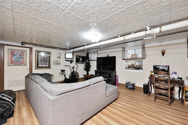 living area featuring an ornate ceiling and wood finished floors