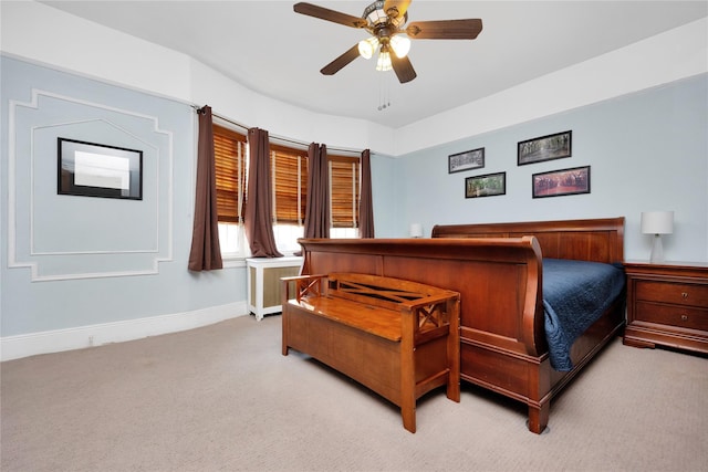 bedroom featuring baseboards, a ceiling fan, and light colored carpet