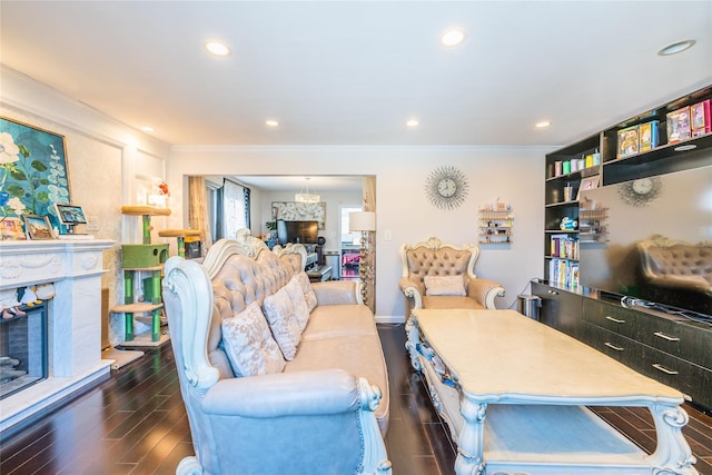 living room with ornamental molding, a fireplace, recessed lighting, and wood finished floors