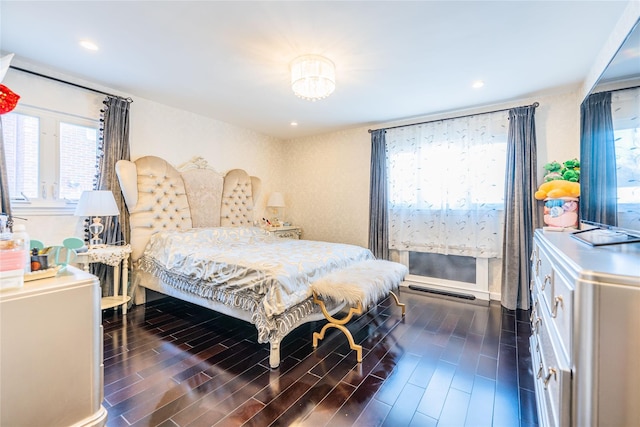 bedroom with recessed lighting, dark wood finished floors, and multiple windows