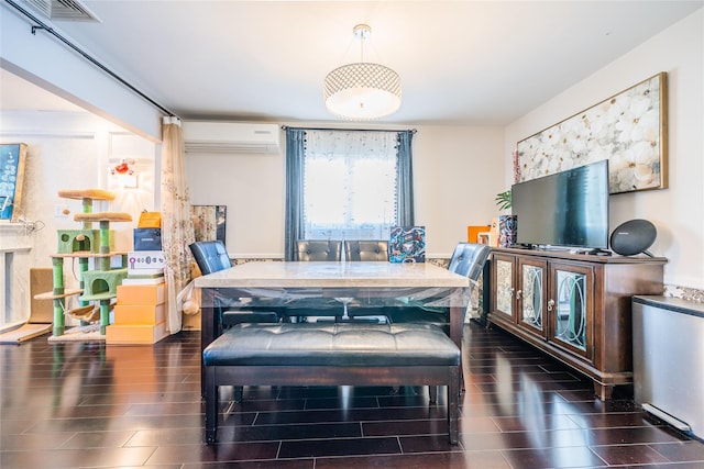 dining area with visible vents, a wall mounted air conditioner, and wood finish floors