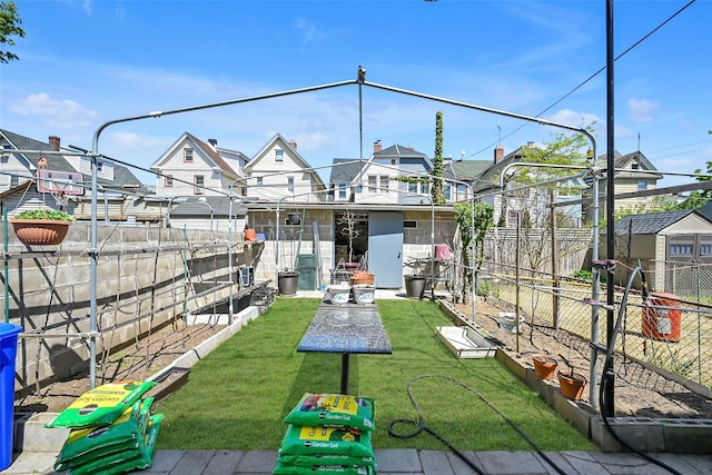 87-71 111th St, Richmond Hill, NY 11418 - back of house with a lawn, fence, and a residential view