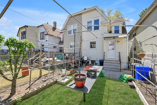 87-71 111th St, Richmond Hill, NY 11418 - rear view of property featuring a yard, a garden, a fenced backyard, and entry steps