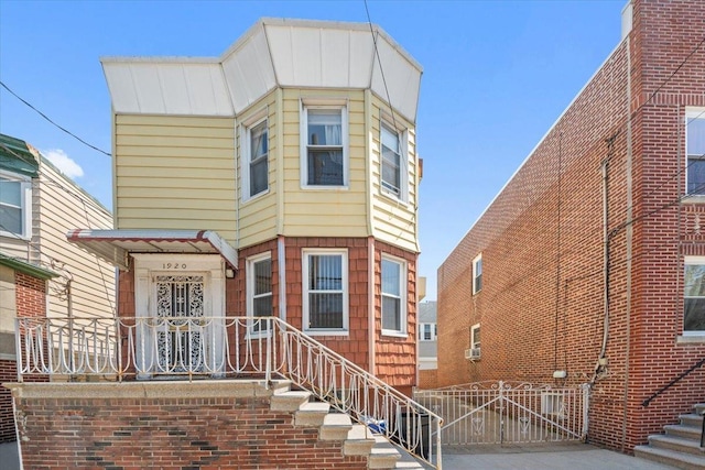 view of front of home featuring fence