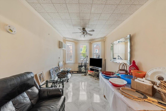 living area featuring a ceiling fan, ornamental molding, and an AC wall unit