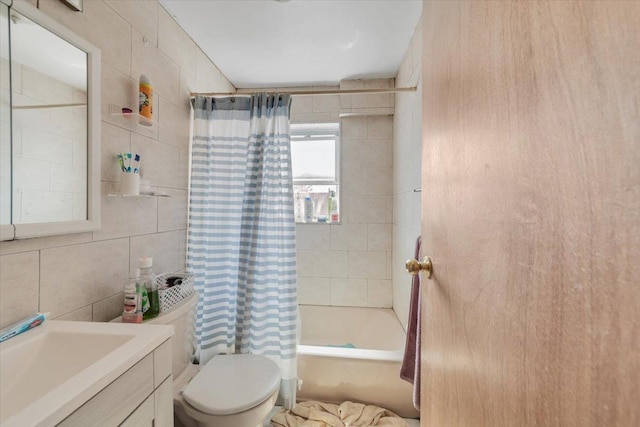 bathroom featuring vanity, tile walls, toilet, and shower / bath combination with curtain