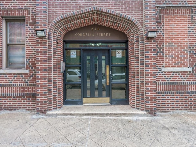 entrance to property with brick siding