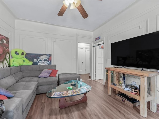 living room with ceiling fan and wood finished floors