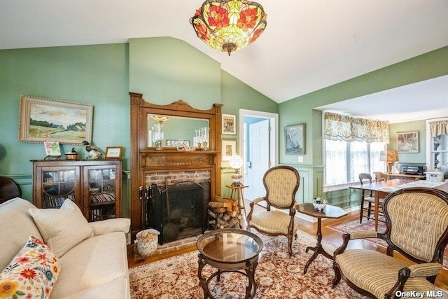 57020 Rte 25, Southold, NY 11971 - living room with wood finished floors, lofted ceiling, and a fireplace